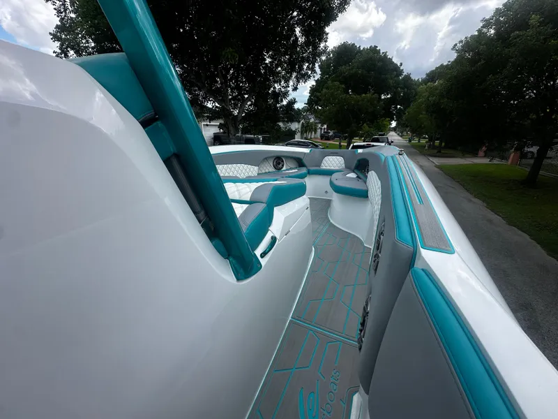 Slide: The Image of 2021 Renegade 38 Open boat interior with teal accents and seating. - 22