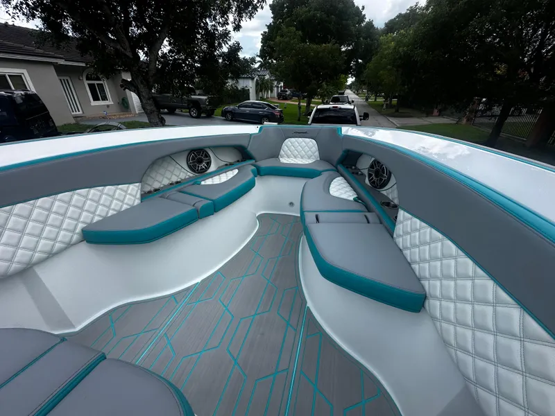 Slide: The Image of 2021 Renegade 38 Open boat interior with teal and gray seating, quilted accents, and modern design. - 24