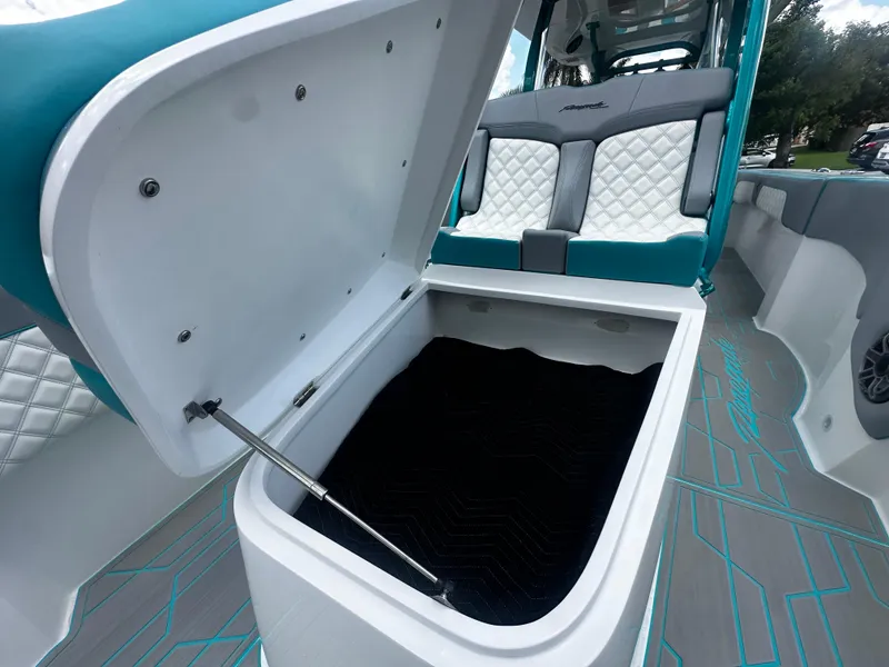 Slide: The Image of Open storage compartment on 2021 Renegade 38 Open boat with cushioned seating. - 26