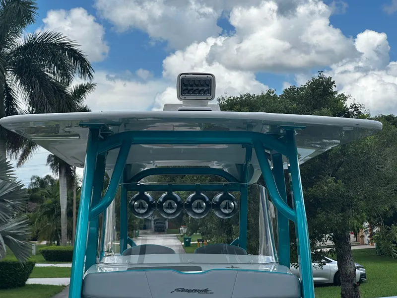 Slide: The Image of 2021 Renegade 38 Open boat with blue accents under a cloudy sky. - 27