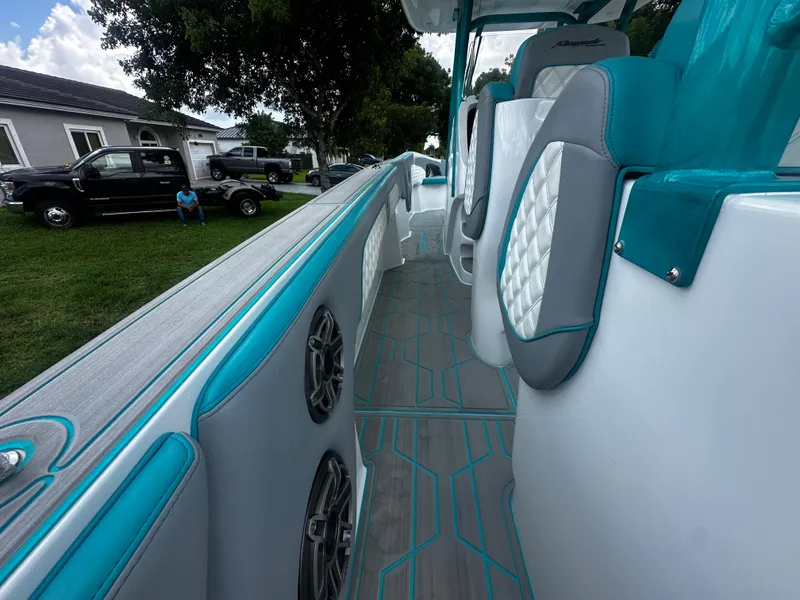 Slide: The Image of 2021 Renegade 38 Open boat interior with teal and gray seating, modern design. - 30