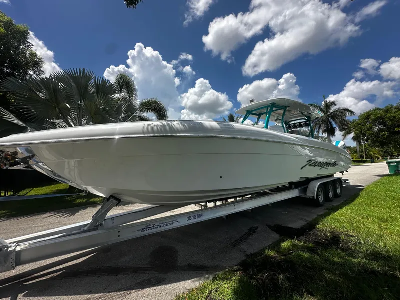 Slide: The Image of 2021 Renegade 38 Open boat on trailer under a sunny sky. - 34