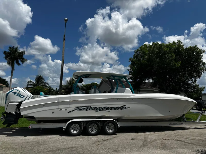 Slide: The Image of 2021 Renegade 38 Open boat on trailer under a cloudy sky. - 37