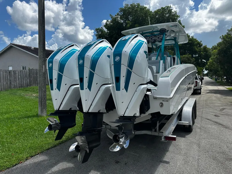 Slide: The Image of 2021 Renegade 38 Open boat with triple outboard engines on a trailer. - 4