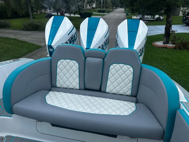 Slide: The Image of 2021 Renegade 38 Open boat with stylish seating and triple outboard engines. - 6