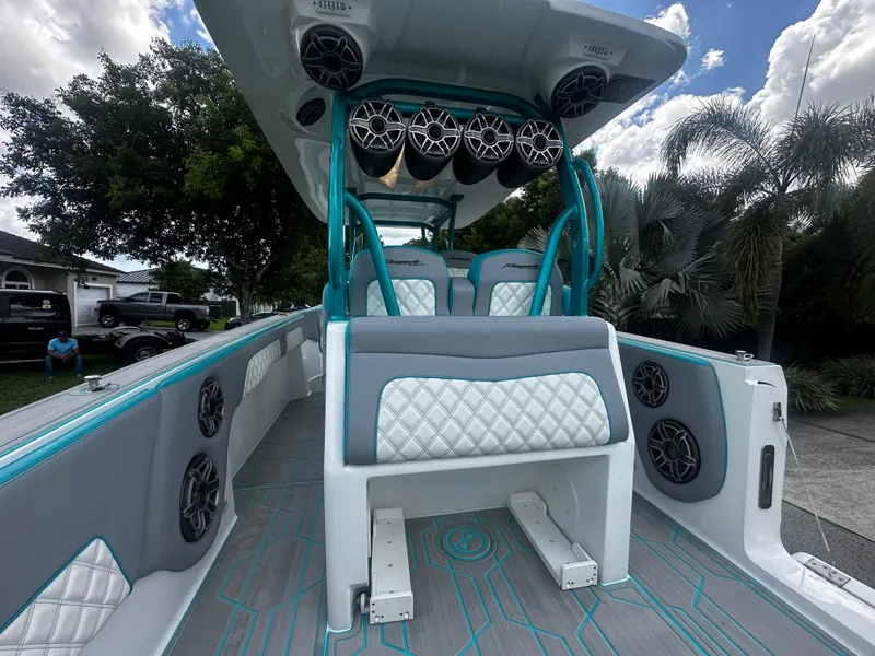Slide: The Image of 2021 Renegade 38 Open boat interior with teal accents and premium seating. - 9