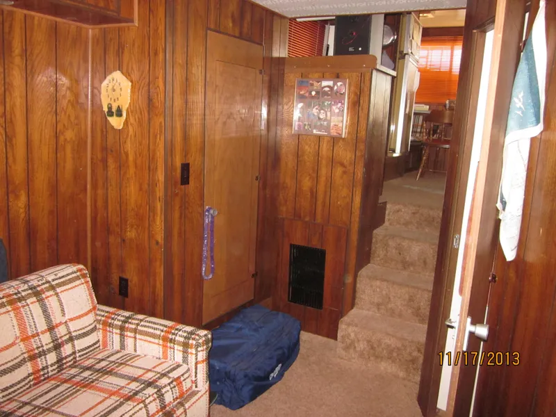 Slide: The Image of Interior of a 1976 Harbor Master houseboat with wood paneling and plaid furniture. - 16