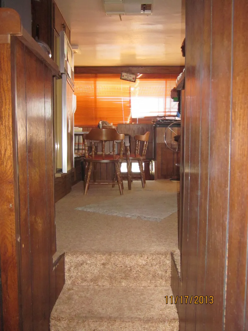 Slide: The Image of Interior of a 1976 Harbor Master houseboat with wooden decor and dining area. - 17