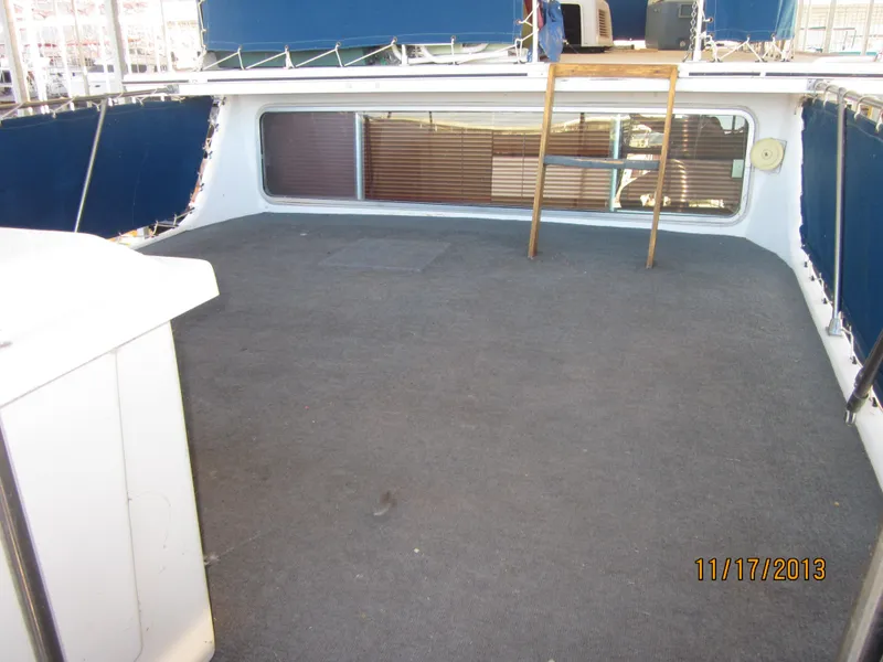 Slide: The Image of 1976 Harbor Master houseboat deck with blue railings and carpeted floor. - 7