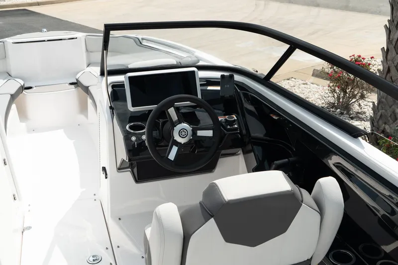 Slide: The Image of 2024 Yamaha AR250 boat cockpit with modern steering and dashboard. - 10