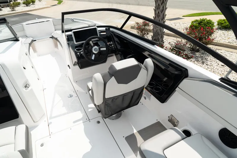 Slide: The Image of 2024 Yamaha Boats AR250 cockpit with modern steering and seating. - 13