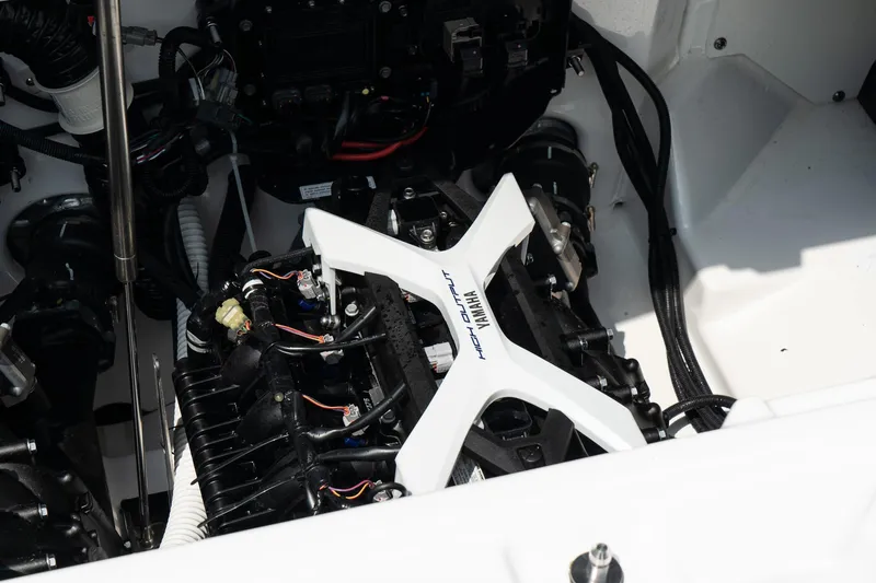 Slide: The Image of Engine compartment of 2024 Yamaha Boats AR250, showcasing mechanical components and wiring. - 22