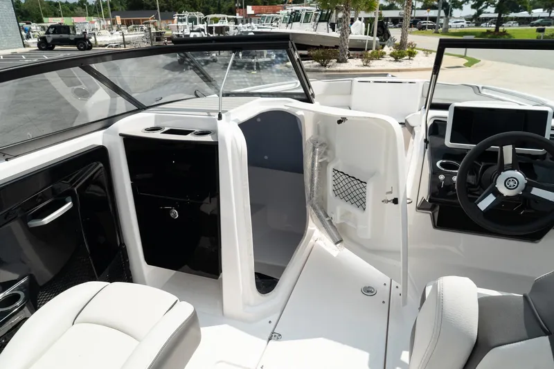 Slide: The Image of 2024 Yamaha Boats AR250 interior with steering wheel and seating area. - 25