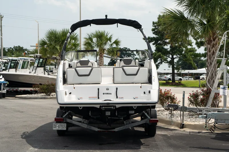 Slide: The Image of 2024 Yamaha AR250 boat on trailer, parked outdoors with palm trees. - 5
