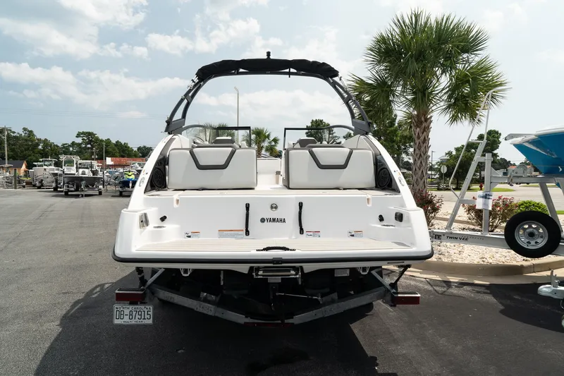 Slide: The Image of 2024 Yamaha Boats AR250, rear view, parked outdoors with palm trees. - 6