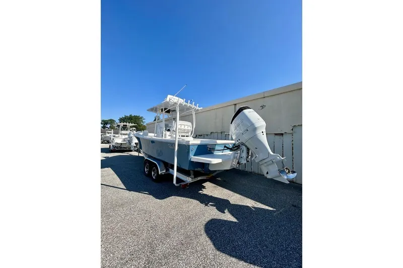 Slide: The Image of 2025 Pair Customs 24 Center Console MV boat on trailer, parked outdoors. - 3