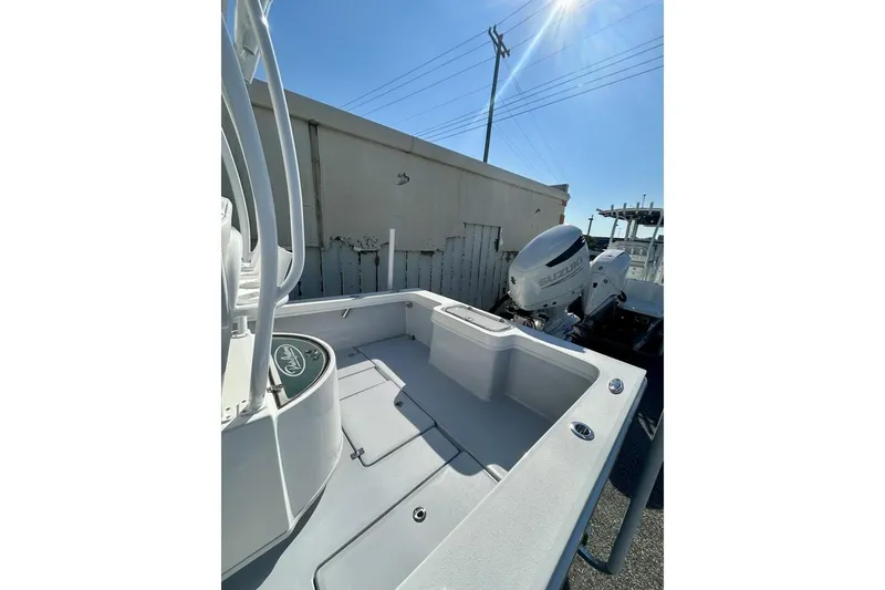 Slide: The Image of 2025 Pair Customs 24 Center Console MV boat, sunlit deck and powerful outboard motor. - 7