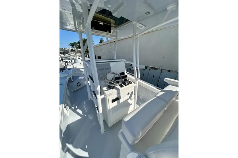 Slide: The Image of 2025 Pair Customs 24 Center Console MV boat interior with steering console and seating. - 8