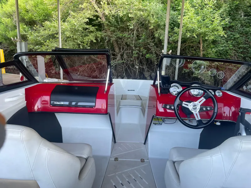 Slide: The Image of 2020 Glastron GT 180 boat interior with red dashboard and white seats. - 3