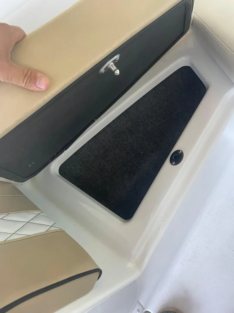 Slide: The Image of Storage compartment in 2020 Glastron GT 180 boat with beige seating. - 4