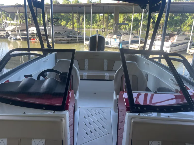 Slide: The Image of 2020 Glastron GT 180 boat interior at marina, featuring sleek design and comfortable seating. - 5