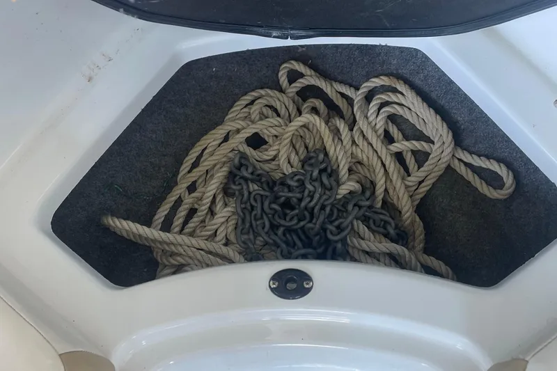 Slide: The Image of Rope and chain storage in 2020 Glastron GT 180 boat compartment. - 8