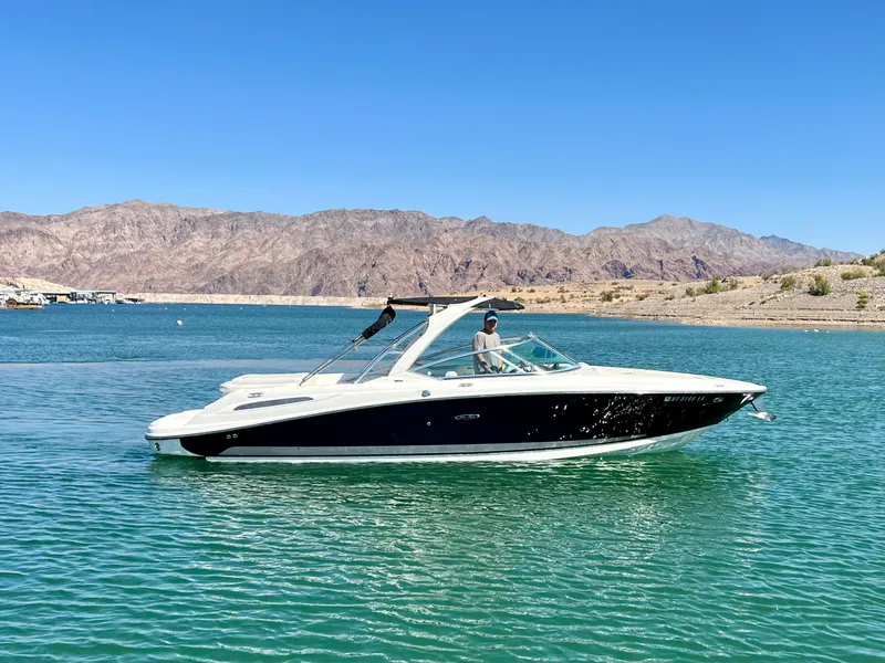 Slide: The Image of 2008 Sea Ray 270 SLX boat cruising on a clear blue lake. - 10