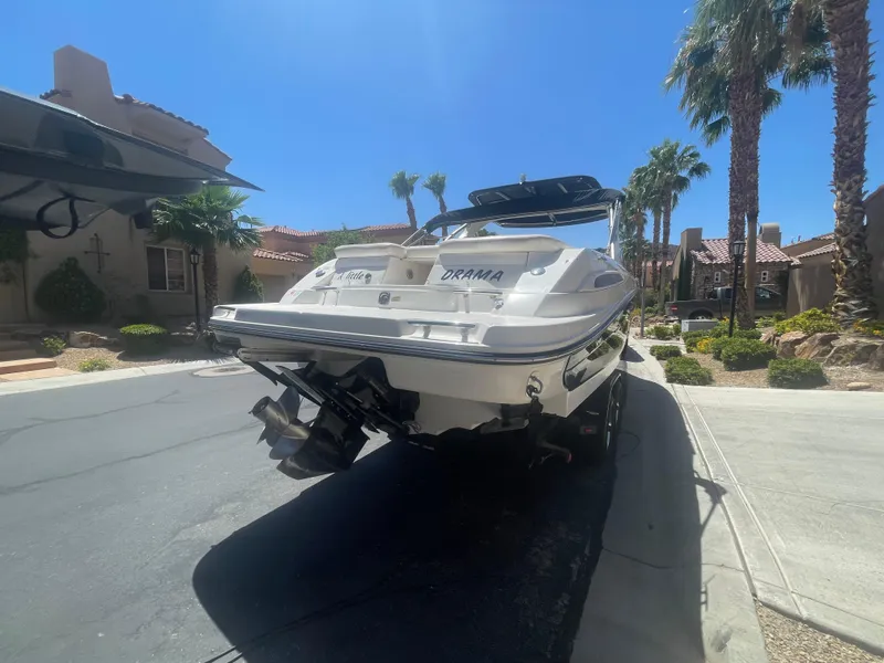 Slide: The Image of 2008 Sea Ray 270 SLX boat parked on a sunny residential street. - 14