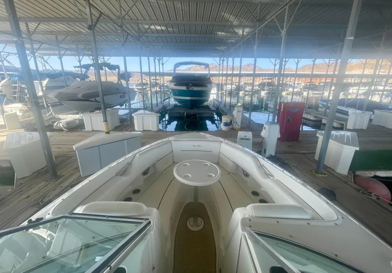 Slide: The Image of 2008 Sea Ray 270 SLX boat docked in a marina under a covered structure. - 16