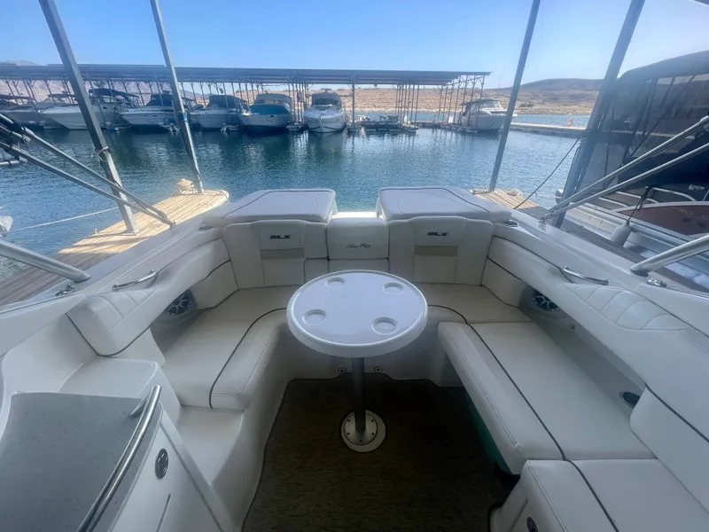 Slide: The Image of 2008 Sea Ray 270 SLX boat interior with seating and table, docked at marina. - 17