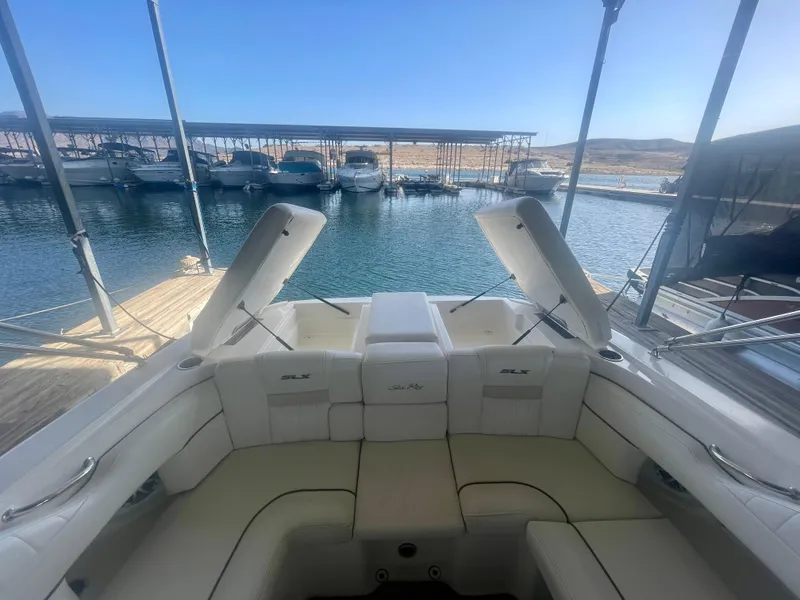 Slide: The Image of 2008 Sea Ray 270 SLX boat interior with open storage compartments at marina. - 18