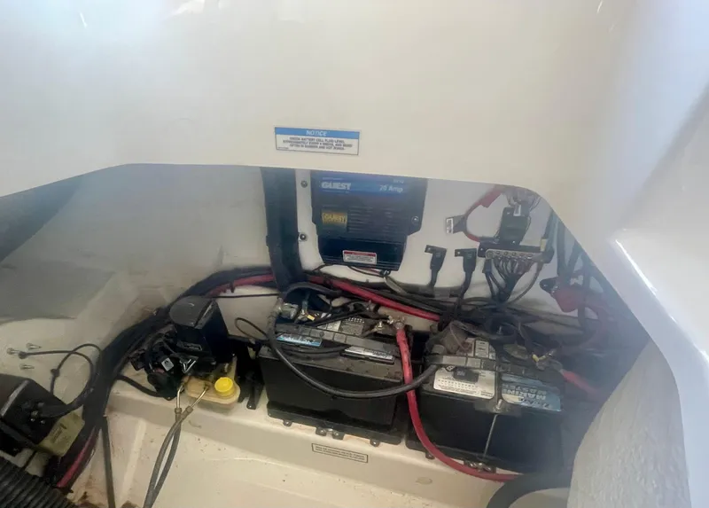 Slide: The Image of 2008 Sea Ray 270 SLX boat battery compartment with wiring and components. - 20