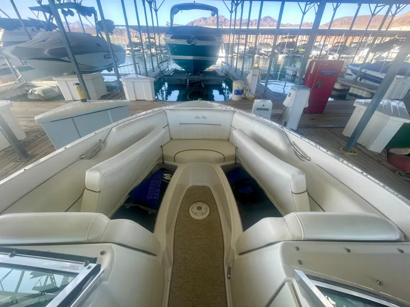 Slide: The Image of 2008 Sea Ray 270 SLX boat interior with white seating in a marina. - 21