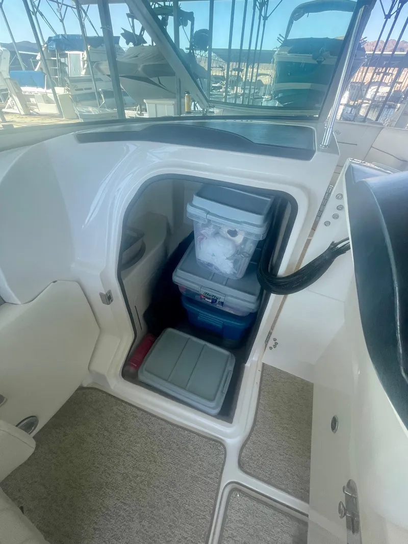 Slide: The Image of 2008 Sea Ray 270 SLX boat interior storage area with coolers and supplies. - 23