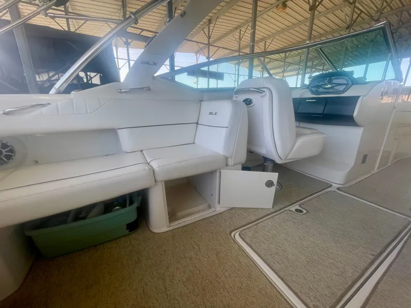 Slide: The Image of 2008 Sea Ray 270 SLX boat interior with white seating and open storage compartment. - 24
