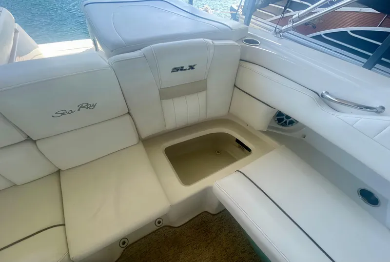 Slide: The Image of 2008 Sea Ray 270 SLX boat interior with white leather seating and storage compartment. - 27