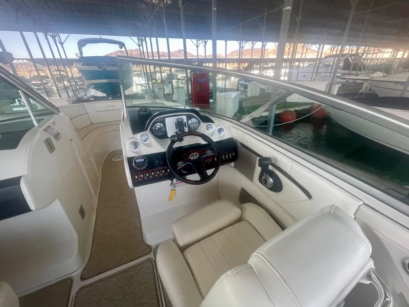 Slide: The Image of 2008 Sea Ray 270 SLX boat interior with steering wheel and dashboard in marina. - 29