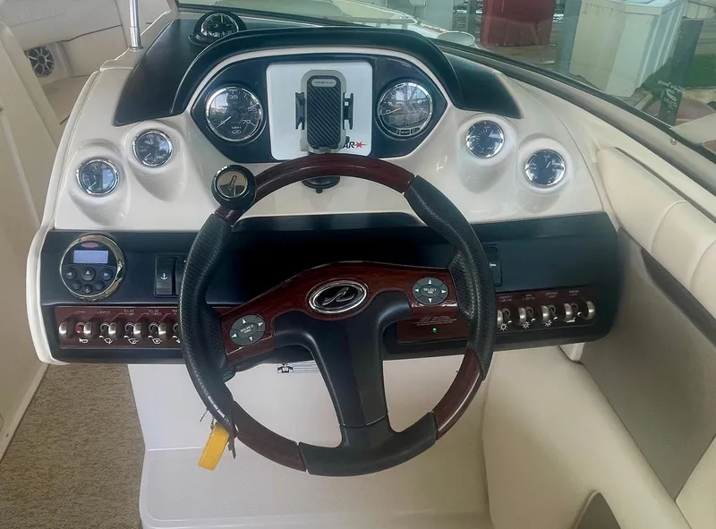 Slide: The Image of 2008 Sea Ray 270 SLX boat dashboard with steering wheel and instrument panel. - 30