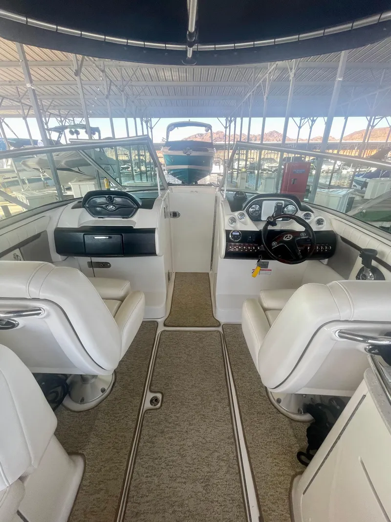 Slide: The Image of Interior of 2008 Sea Ray 270 SLX boat with white seating and helm controls. - 36