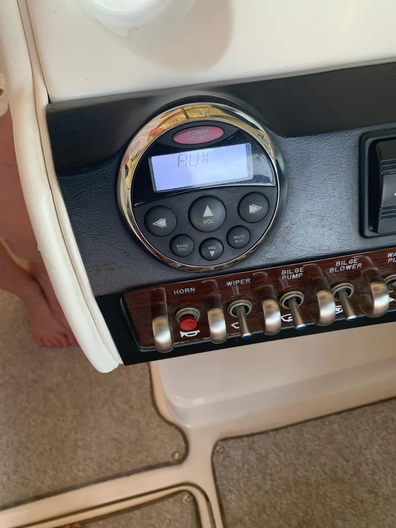 Slide: The Image of Control panel of a 2008 Sea Ray 270 SLX boat with switches and display. - 40