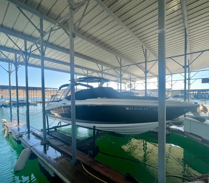 Slide: The Image of 2008 Sea Ray 270 SLX boat docked in a covered marina. - 6