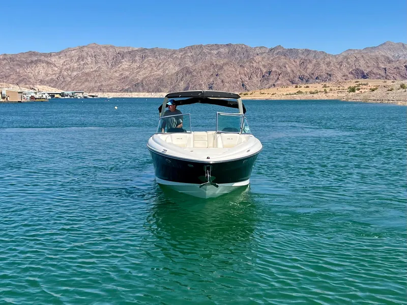 Slide: The Image of 2008 Sea Ray 270 SLX boat on clear blue water with mountain backdrop. - 9