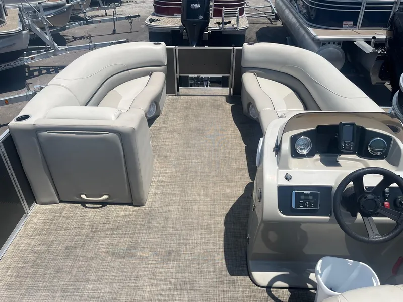Slide: The Image of 2022 Cypress Cay Seabreeze 232 pontoon boat interior with beige seating and helm. - 3