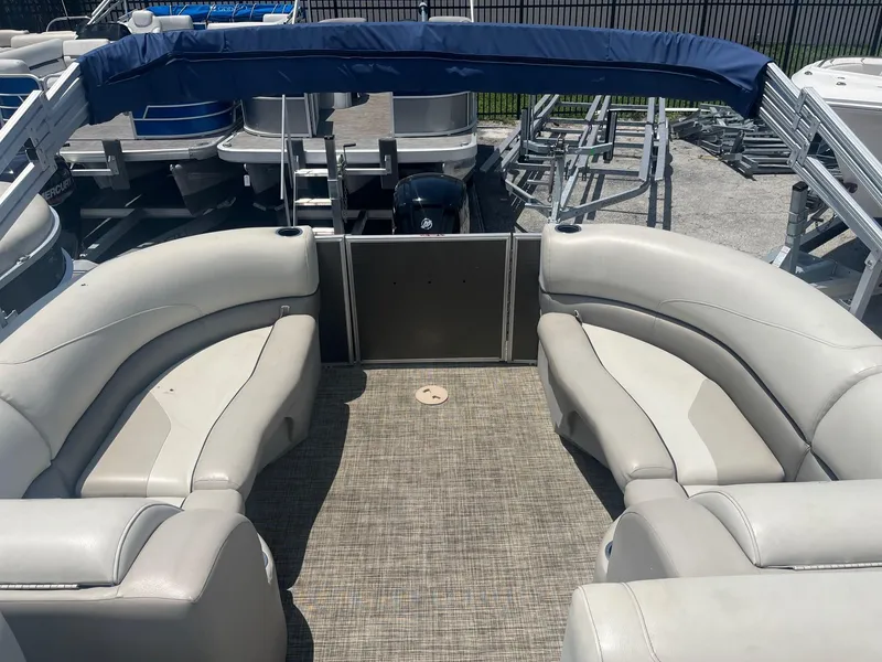 Slide: The Image of 2022 Cypress Cay Seabreeze 232 pontoon boat interior with beige seating and steering console. - 4