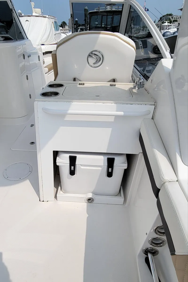 Slide: The Image of 2019 Edgewater 230 CX boat interior with seating and storage area. - 5