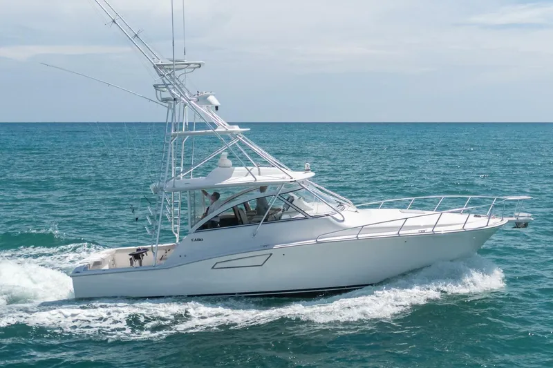 Slide: The Image of 2020 Cabo 40 Express yacht cruising on open sea under clear skies. - 0
