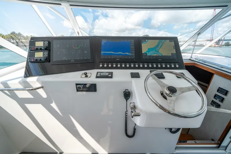 Slide: The Image of Helm of 2020 Cabo 40 Express yacht with advanced navigation displays and controls. - 1
