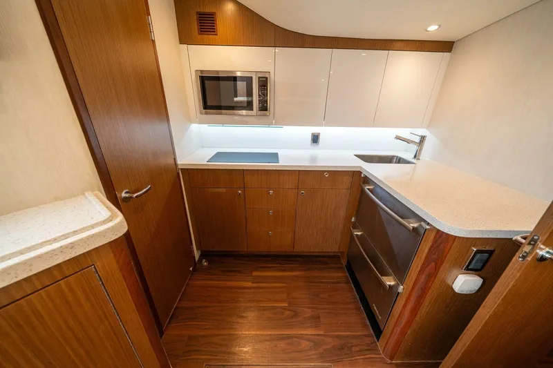 Slide: The Image of Modern kitchen interior of 2020 Cabo 40 Express yacht with wood cabinetry and appliances. - 10