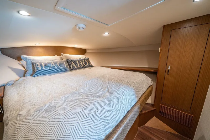 Slide: The Image of Luxurious cabin interior of 2020 Cabo 40 Express yacht with cozy bedding. - 13