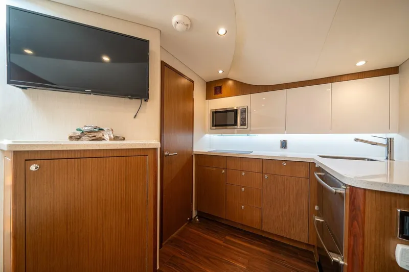 Slide: The Image of Luxurious 2020 Cabo 40 Express yacht interior with modern kitchen and sleek cabinetry. - 15